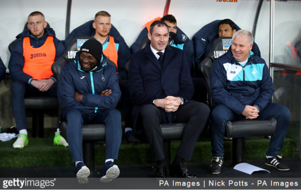 The Swansea City manager, Paul Clement (centre) with his assistence Giggs (right) on the bench during the Premier League match, at the Liberty Stadium. Swansea