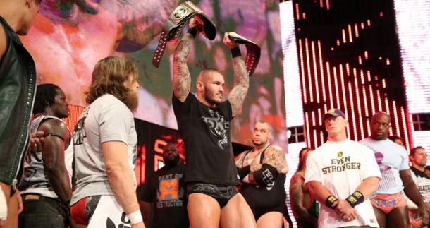 Randy Orton holds up the WWE World Heavyweight Championship(s) in front of John Cena, Smackdown General Manager Daniel Bryan, R-Truth, Brodus Clay and