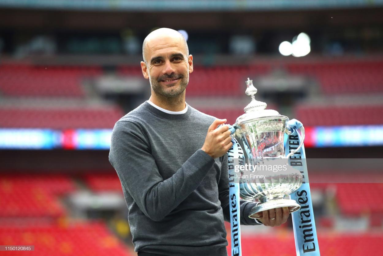 Pep Guardiola lifts the FA Cup trophy following the match between Manchester City and Watford on May 18, 2019. (Photo by Julian Finney/Getty Images)