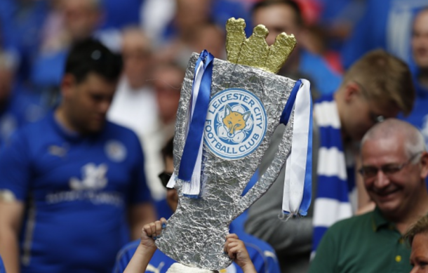 A Leicester supporter lifts a homemade Premier League trophy aloft at Wembley ahead of their Community Shield clash. | Photo: Getty