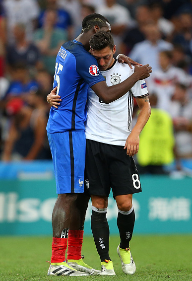Respect: Pogba and an understandably dispondent Ozil embrace at the full-time whistle. | Photo: Getty