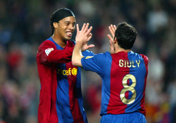 Ronaldinho celebrating one of his goals with Ludovic Giuly. | Photo: Getty