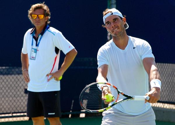 Rafael Nadal serves at practice under the watchful eye of assistant coach Francisco Roig at the 2015 Western & Southern Open in Cincinnati/Rafa Nadal Fans