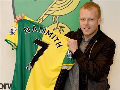 Naismith poses with his new jersey - with him to wear the number seven shirt. | Photo: Norwich City FC