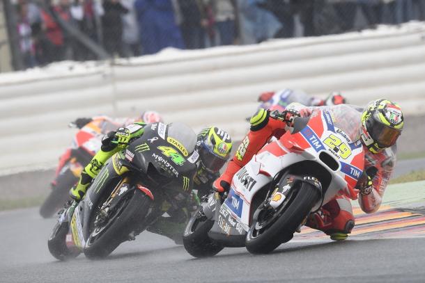 Great action shot in the wet of Iannone and being chased by Bradley Smith - www.ducati.com