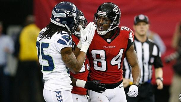 Never one to shy away, Roddy White lets Richard Sherman know what is on his mind after beating him for a touchdown. (Joe Robbins/Getty Images)