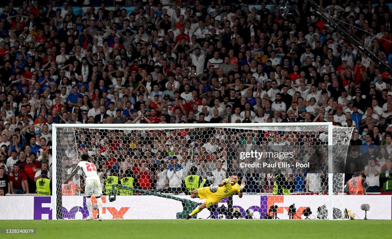 Bukayo Saka of England misses his team's fifth penalty in a penalty shoot out which is saved by Gianluigi Donnarumma of Italy during the penalty shoot out in the UEFA Euro 2020 Championship Final between Italy and England at Wembley Stadium on July 11, 2021 in London, England. (Photo by Paul Ellis - Pool/Getty Images)
