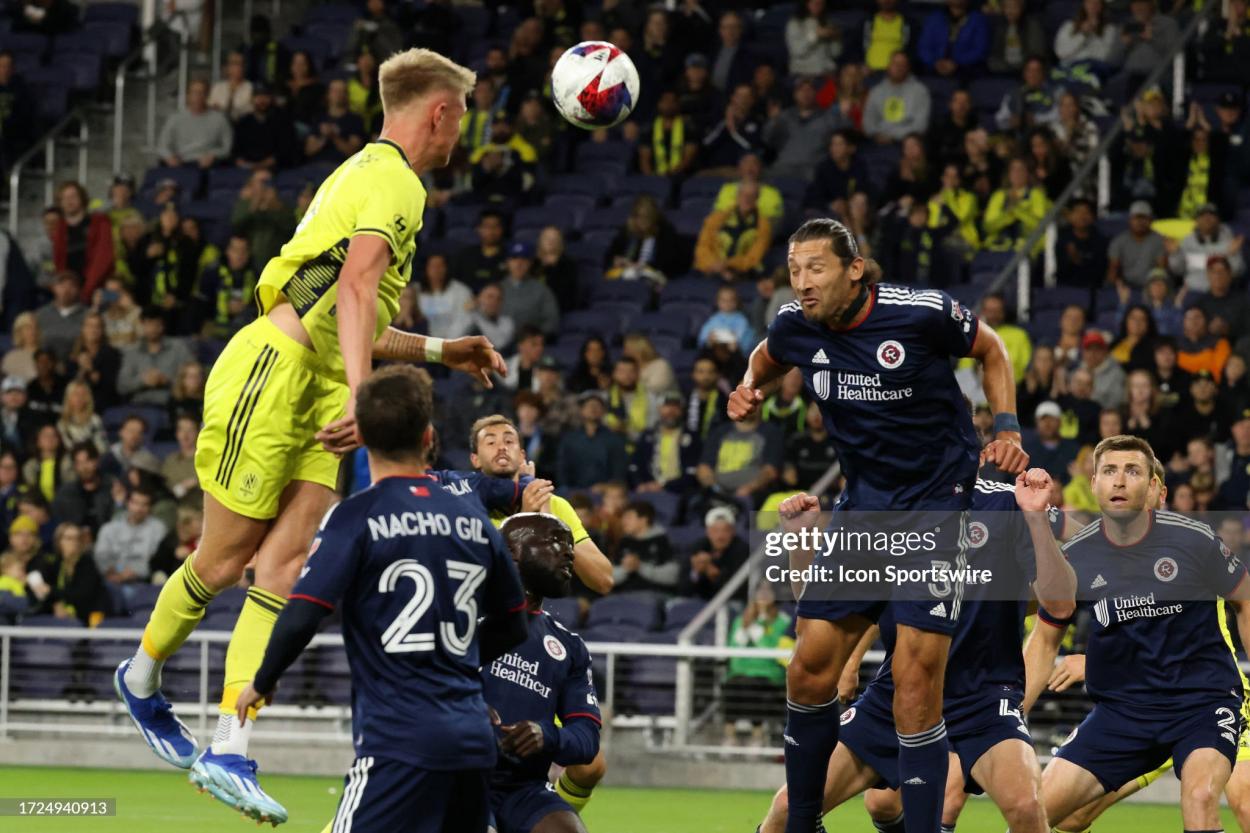 Nashville SC forward Sam Surridge (9) heads a ball in front of New England Revolution defender Omar González (3) during a match between Nashville SC and New England Revolution, October 14, 2023, at GEODIS Park in Nashville, Tennessee. (Photo by Matthew Maxey/Icon Sportswire via Getty Images)