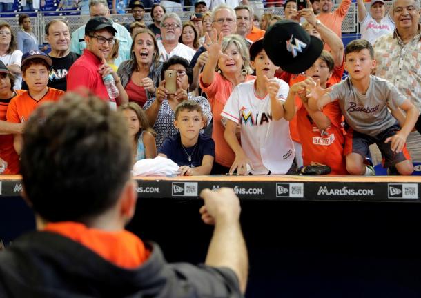 Jose Fernandez tosses his cap to the young fans after a game-AP