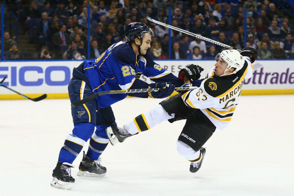 Kevin Shattenkirk #22 of the St. Louis Blues pushes Brad Marchand #63 of the Boston Bruins to the ice at the Scottrade Center on February 6, 2014 in St. Louis, Missouri. (Photo by Dilip Vishwanat/Getty Images)