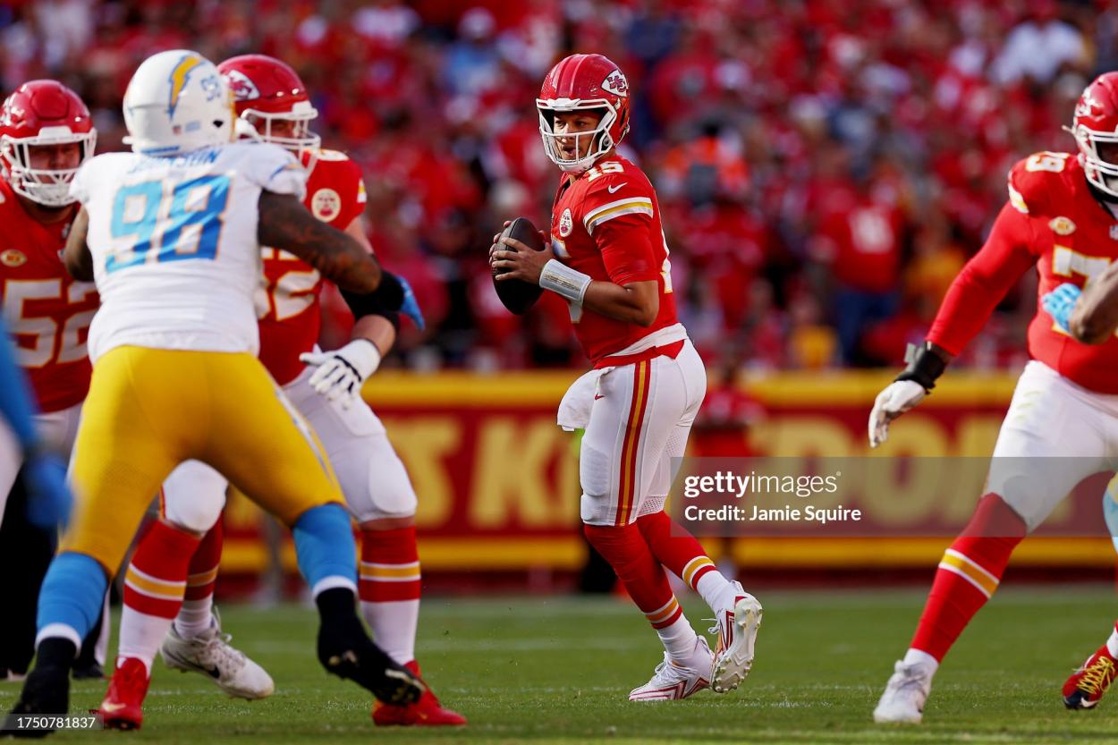 Patrick Mahomes #15 of the Kansas City Chiefs looks to pass during the first quarter against the Los Angeles Chargers at GEHA Field at Arrowhead Stadium on October 22, 2023 in Kansas City, Missouri. (Photo by Jamie Squire/Getty Images)