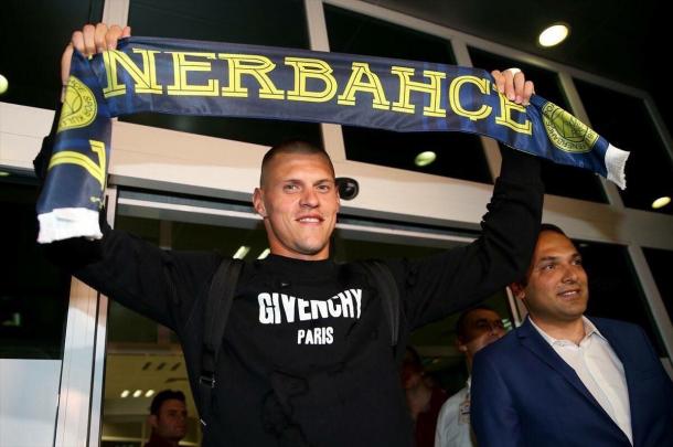 Skrtel pictured with a Fenerbahce scarf shortly after landing at Istanbul Airport on Tuesday. (Picture: Getty Images)