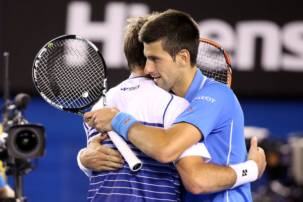 Wawrinka and Djokovic embrace at the net following their semifinal encounter at the Australian Open last year (Photo by Michael Dodge / Getty Images)