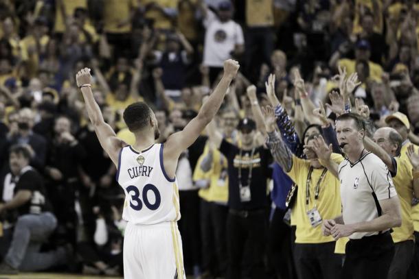 Stephen Curry celebrates as the Warriors approach their title win. Photo: Marcio Jose Sanches/AP Photo.
