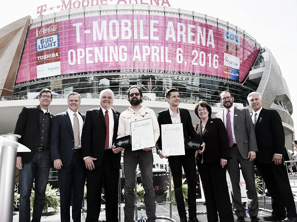 LAS VEGAS, NEVADA - APRIL 06: (L-R) T-Mobile Chief Marketing Officer Andrew Sherrard, MGM Resorts International Chairman and CEO Jim Murren, Clark County Commission Chairman Steve Sisolak, drummer Ronnie Vannucci Jr. and frontman Brandon Flowers of The Killers, Clark County Commissioner Mary Beth Scow, AEG President and CEO Dan Beckerman and President and CEO of Toshiba Global Commerce Solutions Scott Maccabe attend the T-Mobile Arena grand opening news conference on the Las Vegas Strip on April 6, 2016 in Las Vegas, Nevada. (Photo by Ethan Miller/Getty Images for MGM Resorts International)