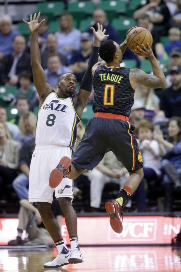 Utah's Shelvin Mack defends a shot by his former teammate, Jeff Teague. | Associated Press