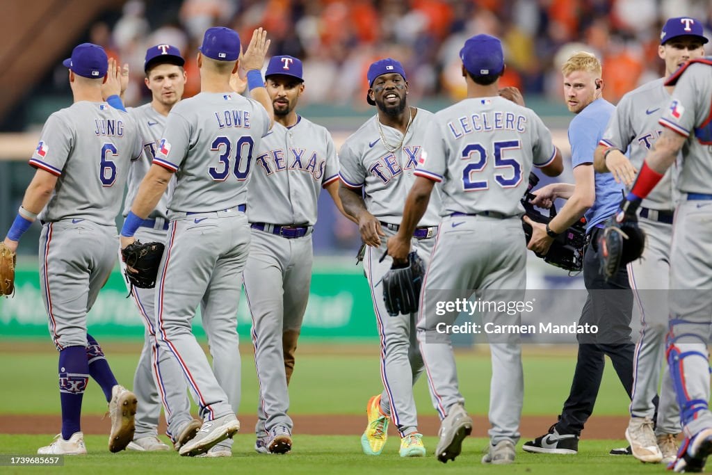 Jose Leclerc #25 of the Texas Rangers celebrates with his teammates after defeating the Houston Astros in Game Two of the American League Championship Series at Minute Maid Park on October 16, 2023 in Houston, Texas. (Photo by Carmen Mandato/Getty Images)