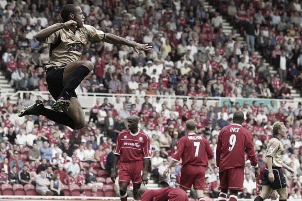 Thierry Henry jumps highest in celebration after opening the scoring in Arsenal's 4-0 rout of Middlesbrough to start the 2001-02 season