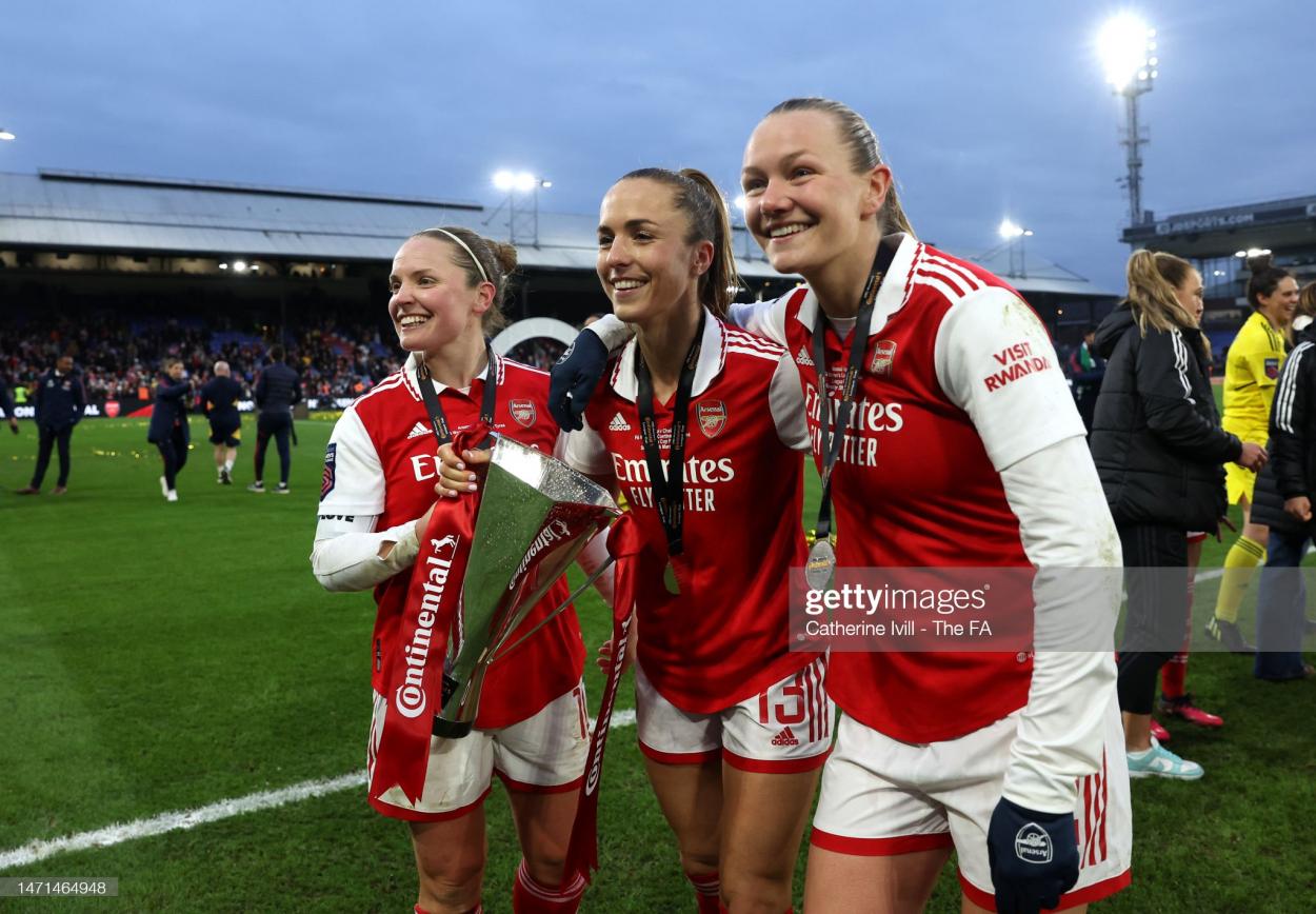 Kim Little holds the trophy with Lia Walti and Frida Maanum. (Photo by Catherine Ivill - The FA/The FA via Getty Images)