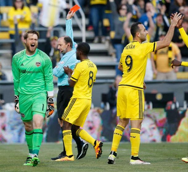 Tyler Deric is shown red after taking down Federico Higuain in the box. Photo courtesy: Barbara Perenic - TNS