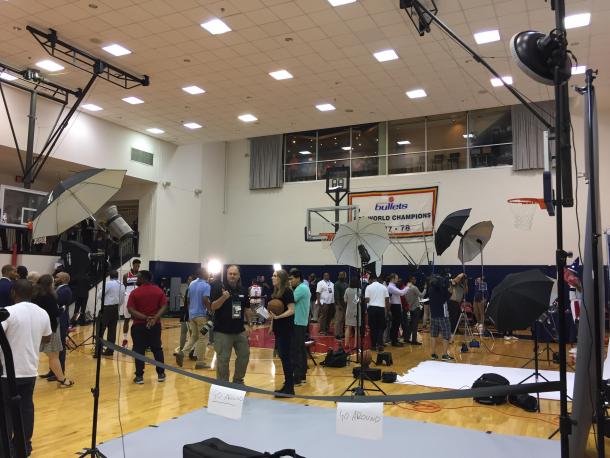 The press gathers around the practice court to take pictures and talk to players. Photo: Raj Sawhney