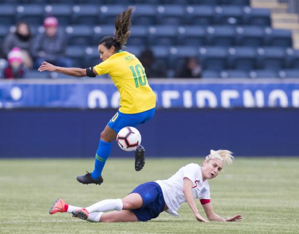 Marta wins the ball and pushes forward to earn a penalty kick for Brazil. | Photo: AP - Chris Szagola