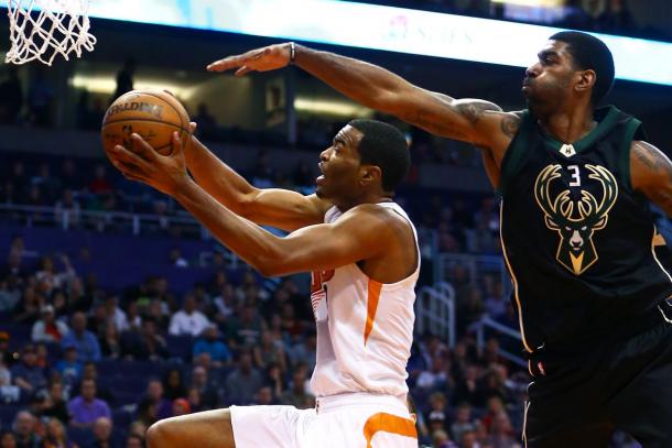 Phoenix Suns forward T.J. Warren (left) drives to the basket against the Milwaukee Bucks guard O.J. Mayo.|Credit: Mark J. Rebilas-USA TODAY Sports|