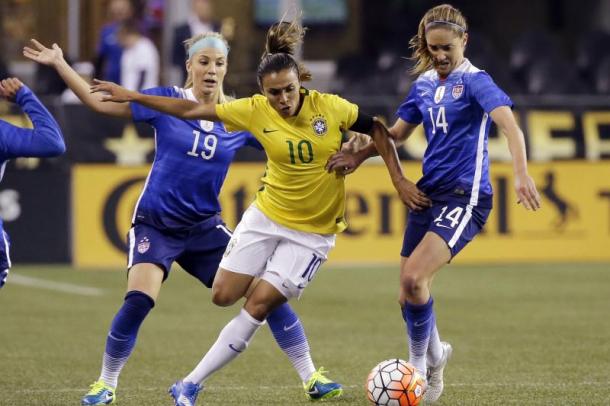 USWNT teammates Julie Ertz (left) and Morgan Brian (right) going up against Brazilian, Marta (middle )in 2015. l Photo: Elaine Thompson/AP