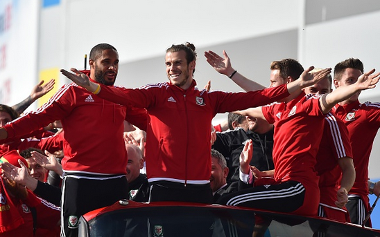 Williams (far left) on Wales' open-top bus parade during their return to Wales after their exploits in France. | Photo: Getty