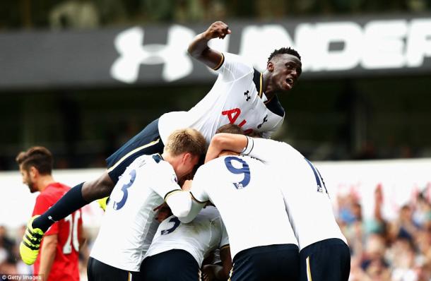 Wanyama leaps on top of his fellow teammates after Spurs equalise (photo: Getty Images)