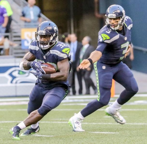Christine Michael takes a handoff from Russell Wilson during their second preseason game. Photo: Kevin Clark / The Herald