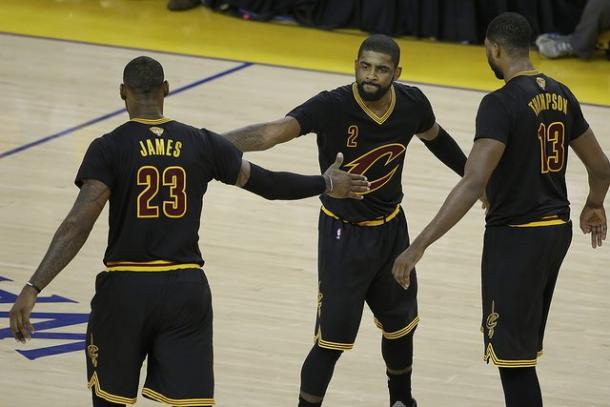 Cleveland Cavaliers' guard Kyrie Irving (2) and forwards LeBron James (23), Tristan Thompson (13) celebrate in Game 5 of the NBA Finals on June 13, 2016. Photo: Jay LaPrete/AFP