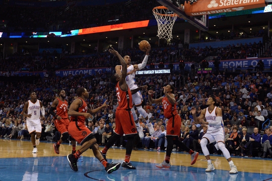 Russell Westbrook drives to the rim as DeMar DeRozan and Terrence Ross defend. PHOTO: Mark D. Smith/USA Today Sports