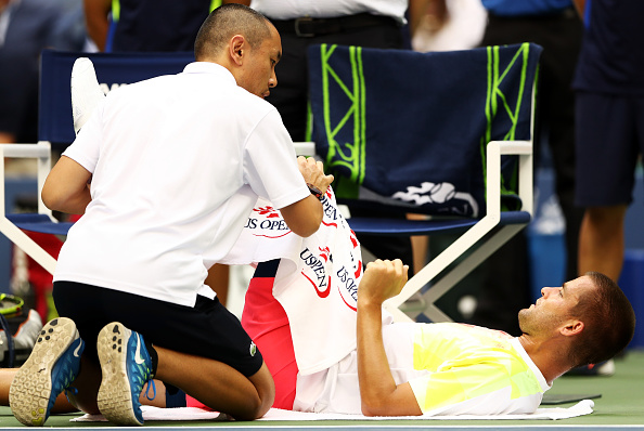 Youzhny receiving treatment for his hamstring (Photo by Elsa / Getty Images)