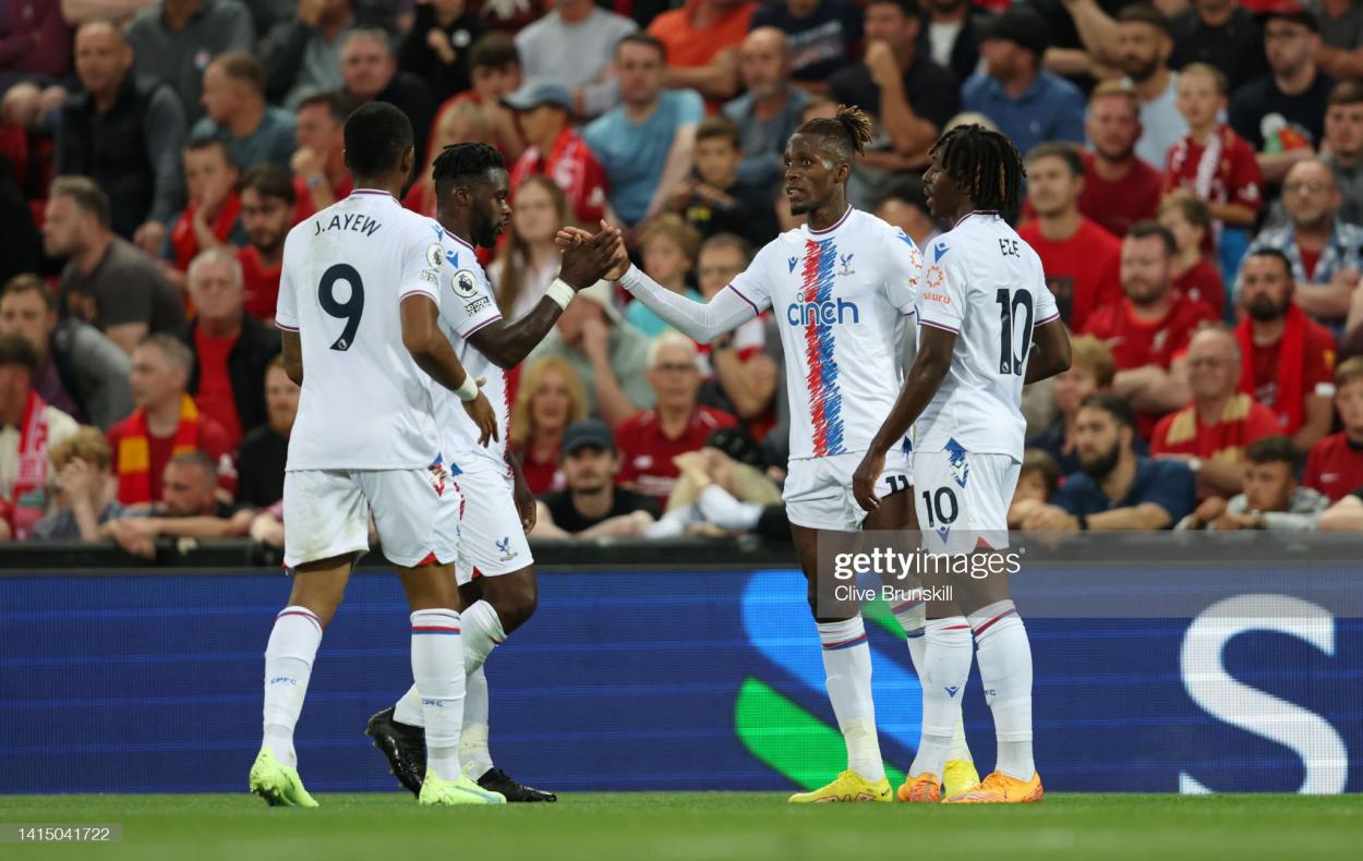 Zaha celebrates with his teammates after scoring versus Liverpool