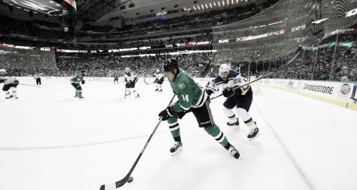 Jamie Benn #14 of the Dallas Stars skates the puck against Paul Stastny #26 of the St. Louis Blues in the third period in Game Seven of the Western Conference Second Round during the 2016 NHL Stanley Cup Playoffs at American Airlines Center on M