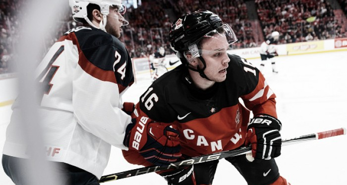 Anthony DeAngelo #24 of Team United States holds back Max Domi #16 of Team Canada in a preliminary round game during the 2015 IIHF World Junior Hockey Championships at the Bell Centre on December 31, 2014 in Montreal, Quebec, Canada. Team Canada
