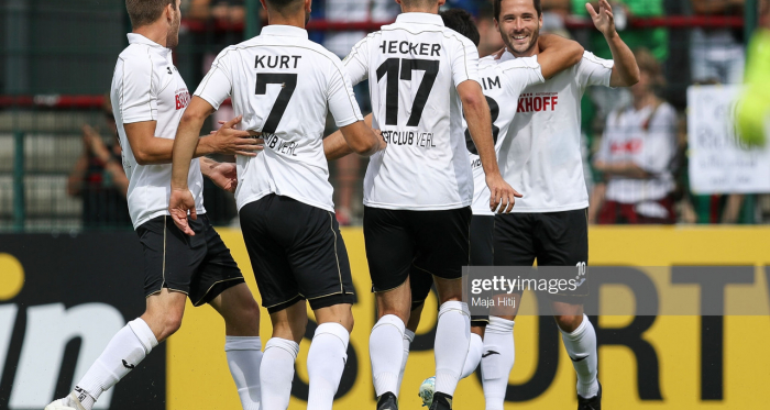 VERL, GERMANY - AUGUST 10: Players of SC Verl celebrate after scoring first goal during the DFB Cup first round match between SC Verl and FC Augsburg at Sportclub Arena on August 10, 2019 in Verl, Germany. (Photo by Maja Hitij/Bongarts/Getty Images)
