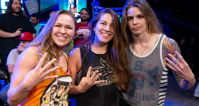 Ronda Rousey (Left) poses with Marina Shafir (Center) and Jessamyn Duke (Right) in support of Shayna Baszler at the Mae Young Classic. | Photo Credit: WWE.com