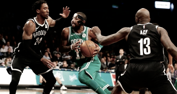 Boston Celtics' Kyrie Irving drives past Brooklyn Nets' Rondae Hollis-Jefferson (24) and Quincy Acy (13). Photo: Jim McIsaac