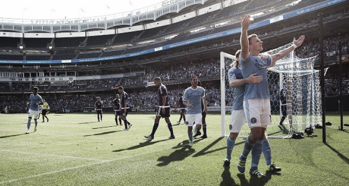 Frederic Brillant (right, in blue) celebrates with teammates after scoring the game's opening goal in New York City FC's 2-2 draw with Orlando City SC on Sunday, May 29. (Photo credit: Tim Clayton/Corbis Images)