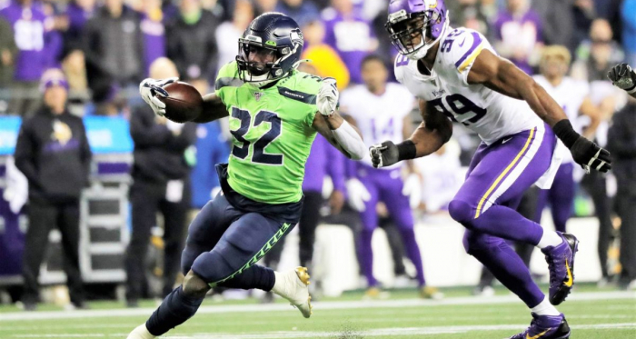 Chris Carson rushes the ball against the Minnesota Vikings. Carson was a major factor in the Seahawks gameplan, and ultimately helped them to a victory and pull ahead in the NFC West. (Ted S Warren / AP Photo)