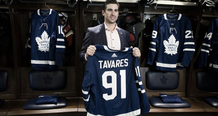 John Tavares holds up a Leafs jersey in the summer after he signed in Toronto. Photo credit - Sportsnet