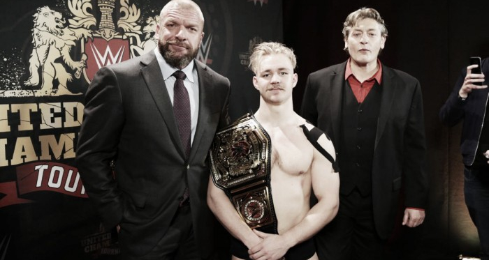 Tyler Bate celebrates his championship win with Triple H and William Regal. Photo: WWE.com