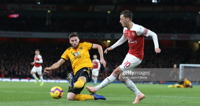 Matt Doherty and Mesut Ozil battle out in the two sides' last meeting in December