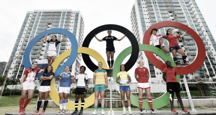 The 12 women's Rugby Sevens captains line-up under the Olympic rings (image via: worldrugby.org)