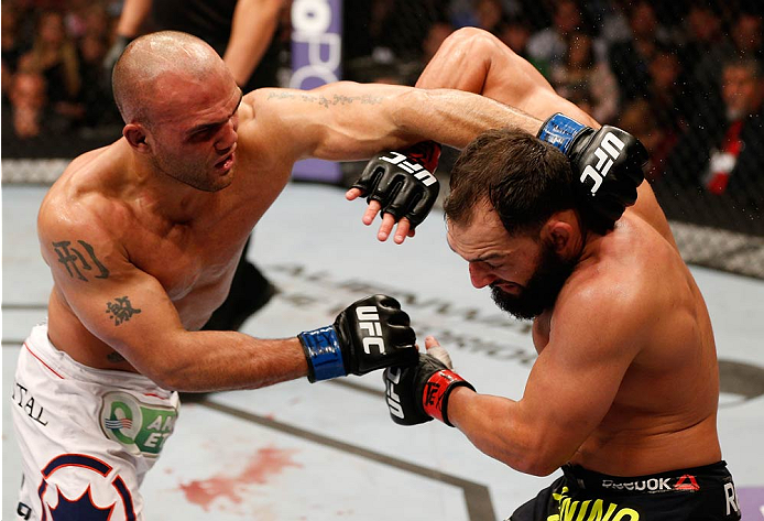 Robbie Lawler punches Johny Hendricks in their UFC welterweight championship bout at UFC 171 inside American Airlines Center on March 15, 2014 in Dallas, Texas. (Photo by Josh Hedges/Zuffa LLC/Zuffa LLC via Getty Images)