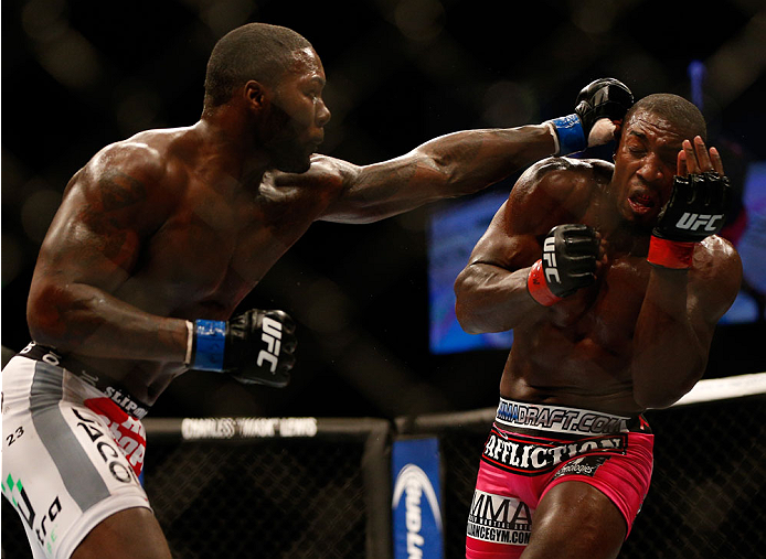 Anthony Johnson punches Phil Davis in their light heavyweight bout during the UFC 172 event at the Baltimore Arena on April 26, 2014 in Baltimore, Maryland. (Photo by Josh Hedges/Zuffa LLC/Zuffa LLC via Getty Images)