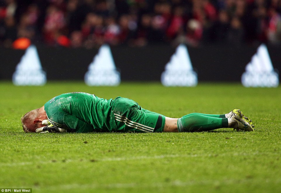Goalkeeper Schmeichel lies dejected following the match (photo: BPI)