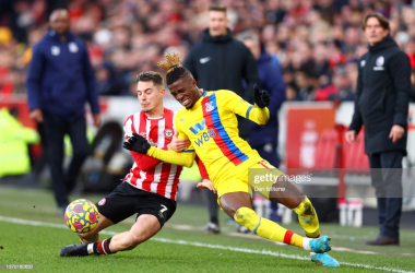 Wilfried Zaha battles for possession with Sergi Canos